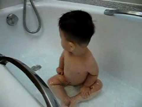 Zensen is playing with water in the hotel bathtub